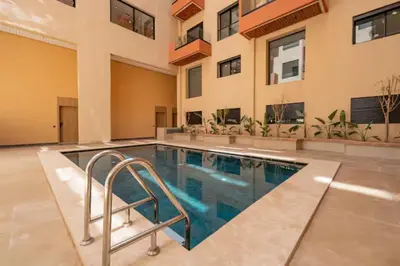 a swimming pool in front of a building at Cozy Studio in Hivernage 31 in Marrakech