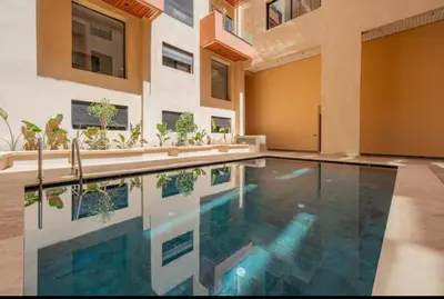 a swimming pool in the middle of a house at Cozy Studio in Hivernage 31 in Marrakech