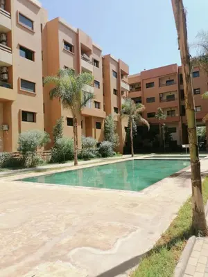 an empty swimming pool in front of a building at Ochre City apartment Balcony, Pool, Fiber Optic, Free Parking - Family ONLY in Marrakech