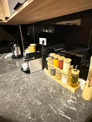 a kitchen counter with many jars of food on it at Riad apartment Beldi style in Marrakech