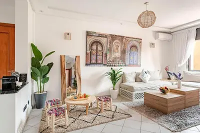 a living room with a couch and a table at Modern Elegance & Moroccan Charm - Gueliz Center in Marrakech