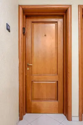a wooden door in a room with at Modern Elegance & Moroccan Charm - Gueliz Center in Marrakech