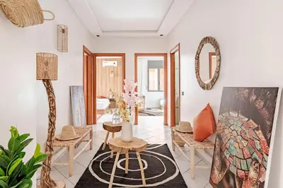 a living room with a table and chairs and a mirror at Modern Elegance & Moroccan Charm - Gueliz Center in Marrakech