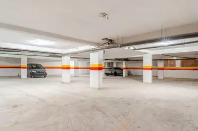 a parking garage with two cars parked in it at Élégant et confortable, près de l'aéroport et de la gare in Marrakech