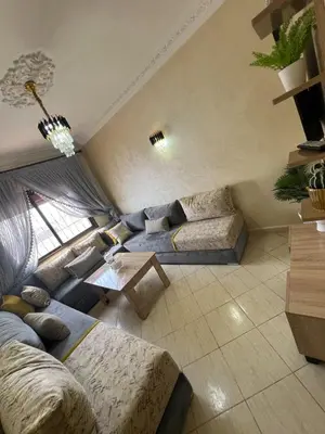 a living room with a couch and a table at Appartement de luxe 15 mn du centre in Marrakech