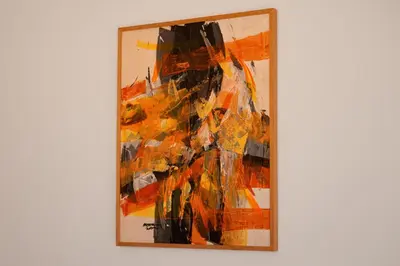 a painting of a woman is hanging on a wall at Appartement yasmina in Marrakech