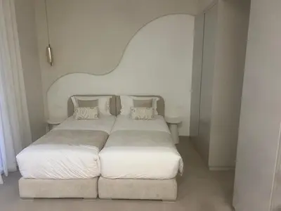 a bedroom with a large bed with white sheets and pillows at Villa Zeytoune sans vis à vis in Marrakech