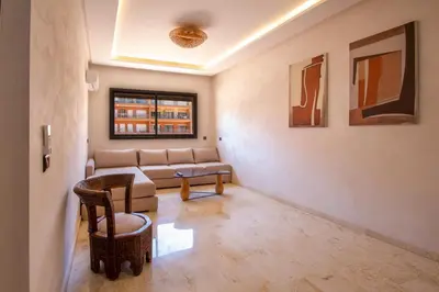 a living room with a couch and a table at Heart of Marrakech - Hivernage 2 bedroom apartment in Marrakech