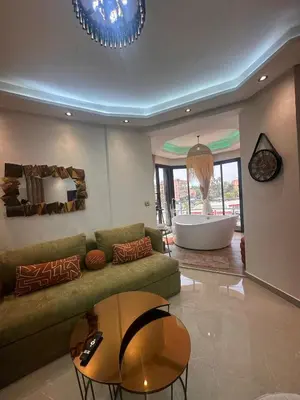 a living room with a couch and a bath tub at Central nest romantic stay in Marrakech