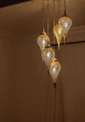 a group of lights hanging from a ceiling at Riad Le Terracotta in Marrakech