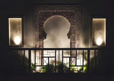a window with a statue of a head on a wall at Riad Madame Riad privé à deux pas de la Place Jemaa El Fna in Marrakech