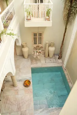 an indoor pool with a bowl of food on the floor at Riad JAIA in Marrakech