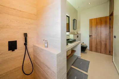 a bathroom with a sink and a shower in a room at Villa Dar Al Jaddah, Luxury and Refinement in Marrakech