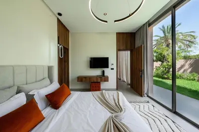 a bedroom with a large bed and a television at Villa Dar Al Jaddah, Luxury and Refinement in Marrakech