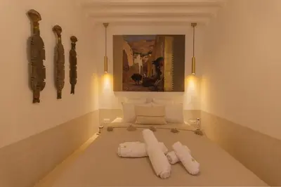 a room with a bed with white pillows on it at Riad Jardin d'Orient in Marrakech
