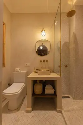 a bathroom with a toilet and a sink and a shower at Riad Jardin d'Orient in Marrakech