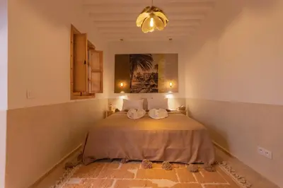 a bedroom with a bed with two towels on it at Riad Jardin d'Orient in Marrakech