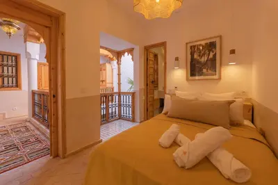 a bedroom with a bed and a balcony at Riad Jardin d'Orient in Marrakech