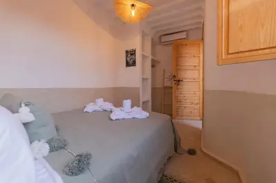 a bedroom with a bed with towels on it at Riad Jardin d'Orient in Marrakech