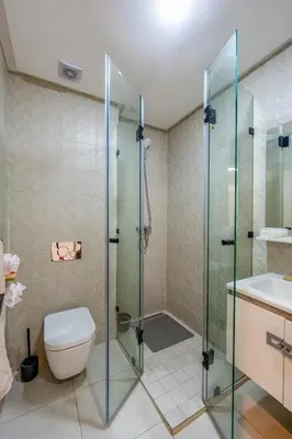 a bathroom with a shower and a toilet and a sink at Urban Dream piscine et central in Marrakech