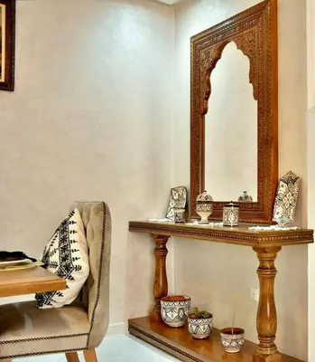 a room with a table and a mirror and a chair at DarKech luxury and comfort in Marrakech