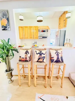 a kitchen with a table and chairs in a room at Full Moon Marrakech in Marrakech
