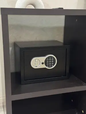 a remote control sitting on a black shelf at Appartement moderne proximité Carré Eden Marrakech in Marrakech