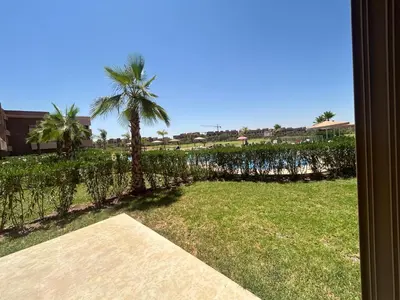 a view of a yard with a palm tree at Relax appartement in Marrakech