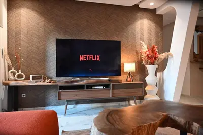 a living room with a television on a wall at Whispers of NATURE in Marrakech
