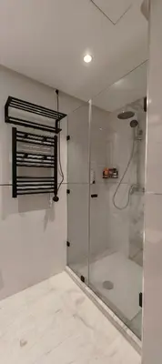 a shower with a glass door in a bathroom at Whispers of NATURE in Marrakech