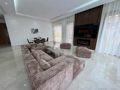 a living room with two couches and a television at Villa del Sur 5 min du centre in Marrakech