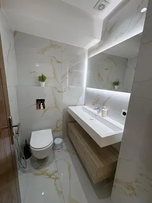 a white bathroom with a toilet and a sink at Villa del Sur 5 min du centre in Marrakech