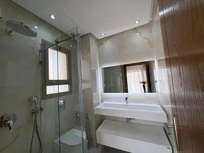 a bathroom with a sink and a glass shower at Villa del Sur 5 min du centre in Marrakech