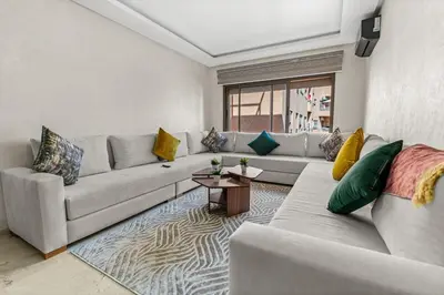 a living room with a couch and a table at Écrin Soleil proche Guéliz et sécurisé in Marrakech