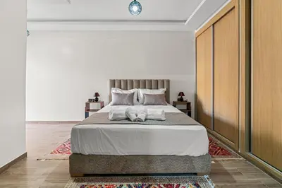 a bedroom with a bed with two towels on it at Écrin Soleil proche Guéliz et sécurisé in Marrakech