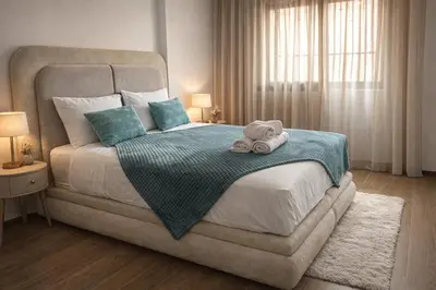 a bedroom with a large bed with a towel on it at Rahma Apartment in Marrakech