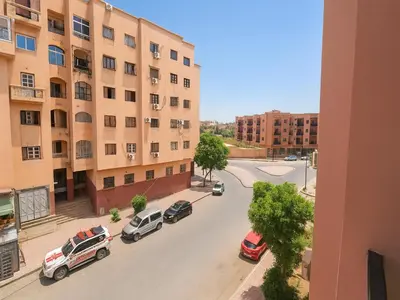 a view of a street with cars parked in a parking lot at Bright 2-BR - Balcony & Parking - Fast Wi-Fi - Near Route de Casa in Marrakech