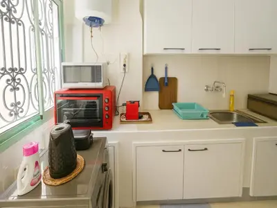 a kitchen with a red microwave on a counter at Bright 2-BR - Balcony & Parking - Fast Wi-Fi - Near Route de Casa in Marrakech