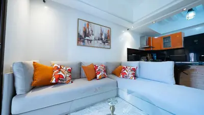 a living room with a blue couch with pillows at Chic City Studio in Marrakech in Marrakech