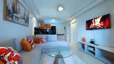 a living room with a couch and a tv at Chic City Studio in Marrakech in Marrakech