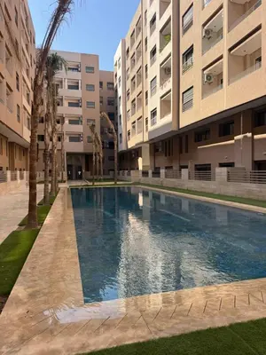 a swimming pool in the middle of a building at Menara Garden - 3 Ch - Piscine - 2 min de M Avenue in Marrakech