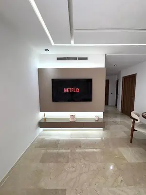 a living room with a television on a wall at Menara Garden - 3 Ch - Piscine - 2 min de M Avenue in Marrakech