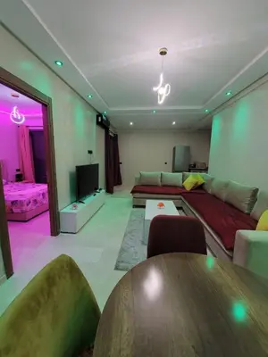 a living room with a couch and a table at Modern Apartment with Pools & Free Parking in Marrakech