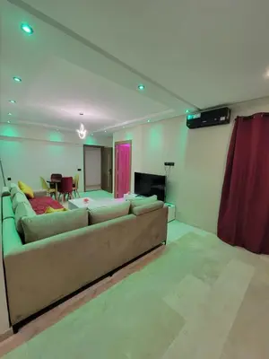 a living room with a couch and a table at Modern Apartment with Pools & Free Parking in Marrakech