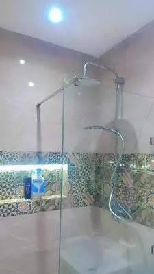 a shower with a glass door in a bathroom at Appartement,kech in Marrakech
