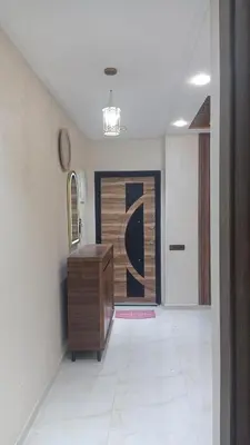 a hallway with a desk and a painting on the wall at Appartement,kech in Marrakech