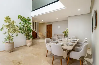 a dining room with a table and chairs at L'Elara - Semlalia - Duplex - Piscine in Marrakech