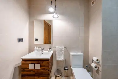 a bathroom with a sink and a toilet and a mirror at L'Elara - Semlalia - Duplex - Piscine in Marrakech