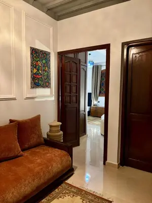 a living room with a couch and a corridor at Dar Diaft'na in Marrakech