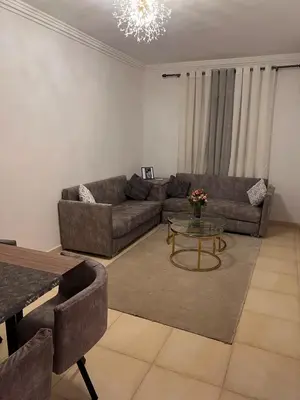 a living room with a couch and a table at New, quiet and comfortable in Marrakech